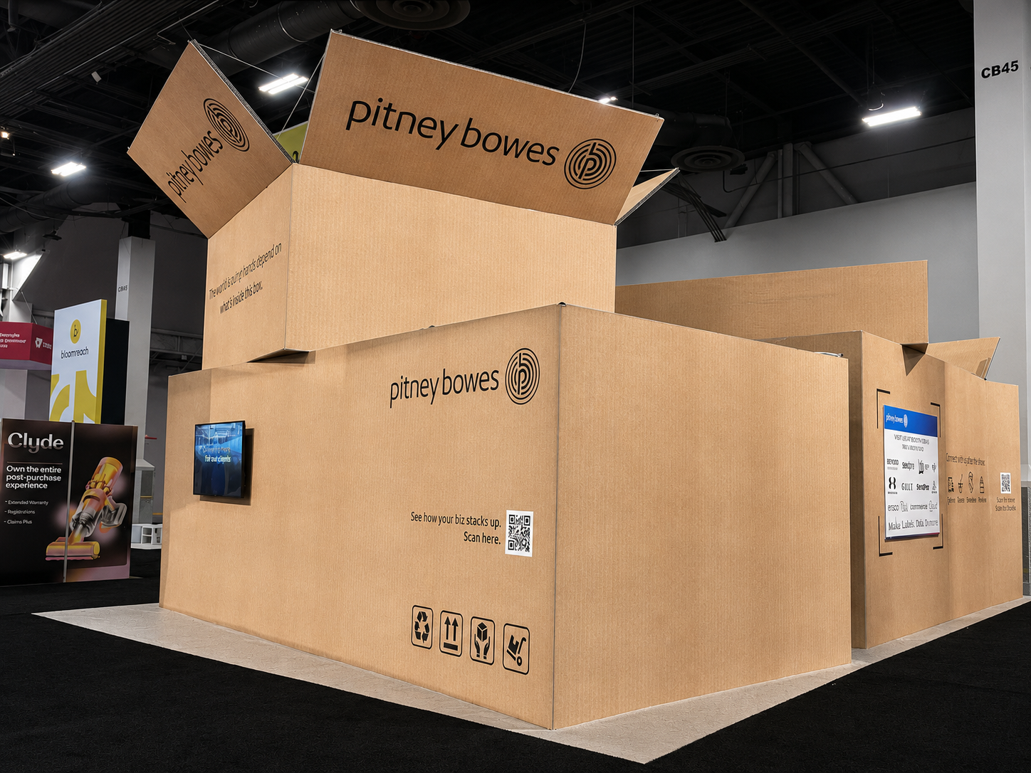 Rear overview of the Pitney Bowes exhibit and oversized box structure